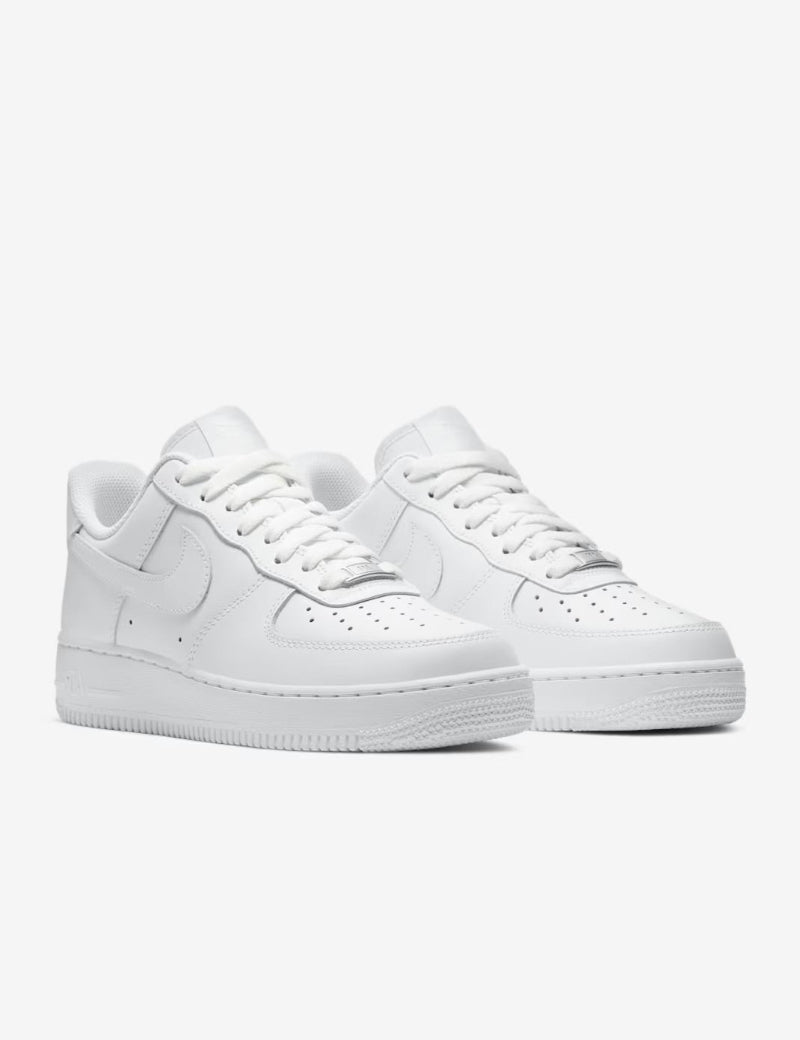 Pair of white sneakers on a light gray background