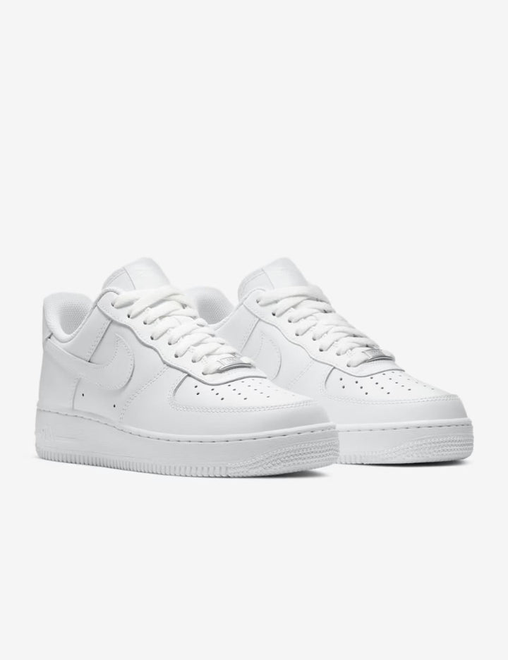 Pair of white sneakers on a light gray background
