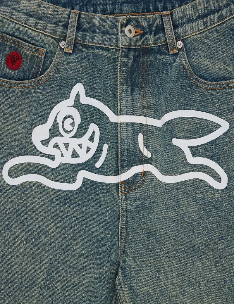 Blue denim jeans with a white cartoon cat design on the back pocket.