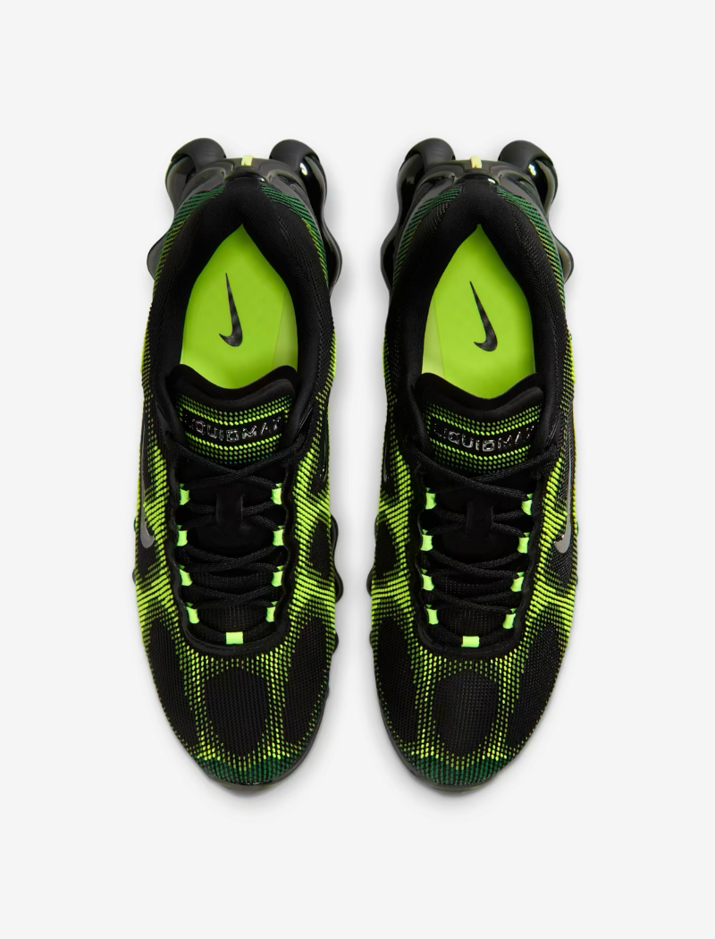 Black and green Nike sneakers on a white background