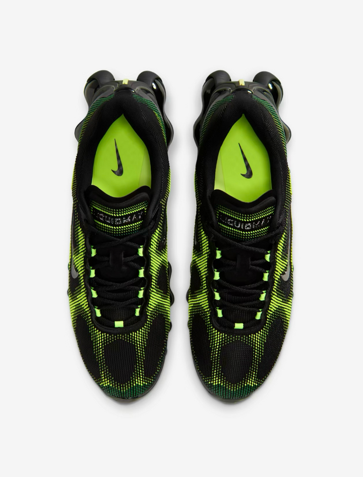Black and green Nike sneakers on a white background