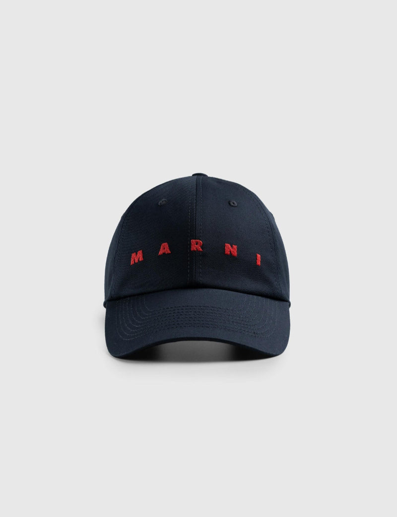 Navy blue cap with red 'Marni' logo on a light gray background